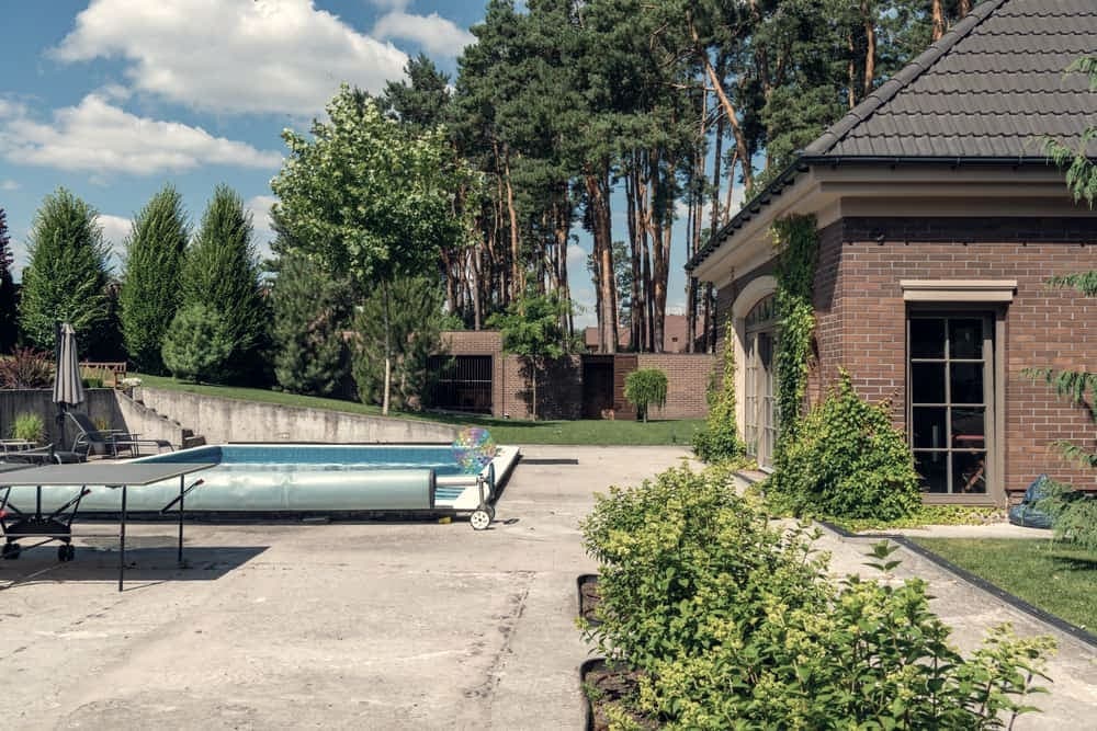 A quiet backyard swimming pool seen from the deck