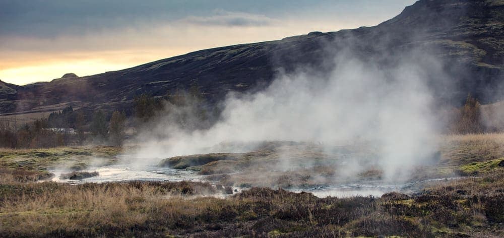 Steam rising from warm water into cool air