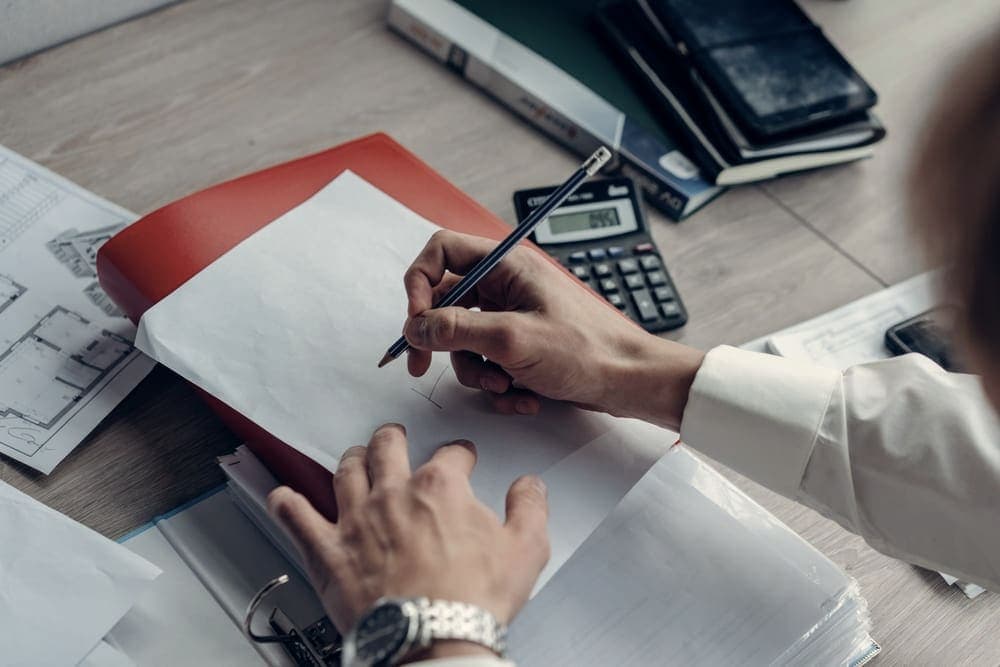 A notebook of worked calculations on a desk