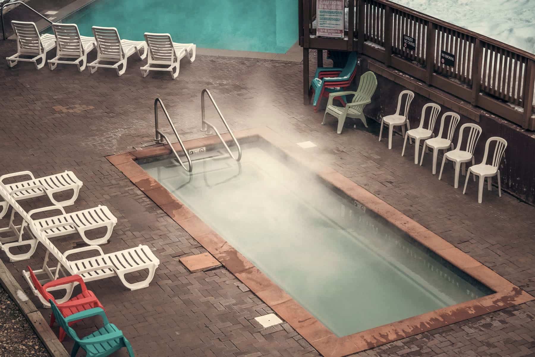 A backyard swimming pool in the low light of early autumn
